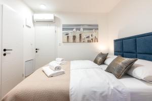 a bedroom with a bed with towels on it at City Premium Heritage in Zadar