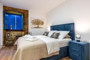 a bedroom with a large bed and a window at City Premium Heritage in Zadar