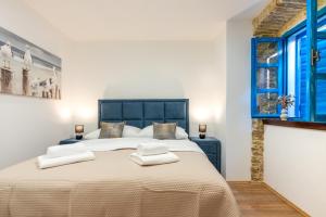 a bedroom with a large bed with towels on it at City Premium Heritage in Zadar