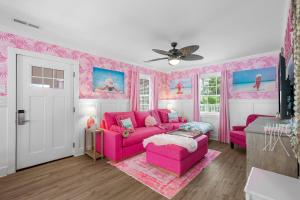 a pink living room with a pink couch at Pink Prerogative Beach Bungalow with Private Pool in Panama City Beach +43 photos