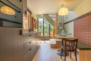 a kitchen with a table and a dining room at L'Observatoire Sauvage - Climatisation - Nature - Insolite - Amboise in Amboise