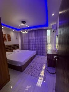 a bedroom with a bed and a large screen at avenue compound in Hurghada +16 photos
