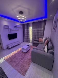 a living room with a couch and a flat screen tv at avenue compound in Hurghada