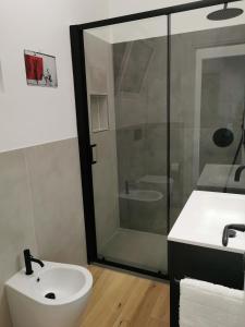 a bathroom with a white sink and a shower at Cuore Rosso in Chiavari +22 photos