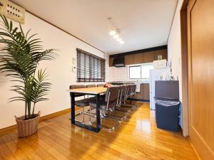 a kitchen and dining room with a table and chairs at スリーチアーズ in Okayama