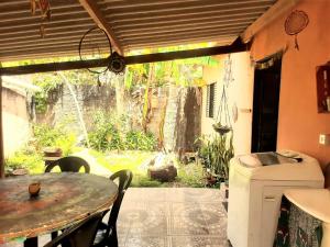 an outdoor patio with a table and a sink at Casa da Pri em São Jorge in Sao Jorge