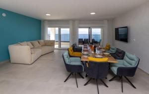 a living room with a table and a couch at Villa Sole Komarna by Villas Guide in Klek