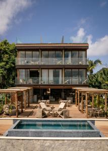 a house with a pool in front of it at Pousada Filó in Fernando de Noronha