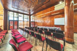 a room with a bunch of chairs and a screen at Hotel Austral by Exsel in Saint-Denis +48 photos