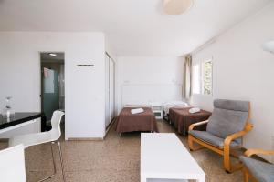 a room with a bed and a table and chairs at Apartamentos Tarahal in San Agustin +55 photos
