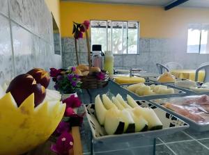 a buffet with cheese and other foods on a table at Pousada Sinai in Viçosa