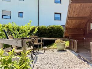 a patio with a table and benches and a building at Apart-Hotel Kastanienhof in Dannenfels +32 photos