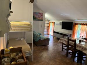 a bedroom with a bunk bed and a dining room at Agriturismo San Michele in San Michele