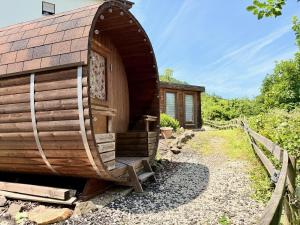 a wooden hobbit house with a pathway leading to it at Apart-Hotel Kastanienhof in Dannenfels