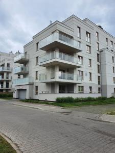 an apartment building with balconies on the side of a street at Mazury Home Apartament in Giżycko