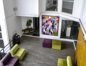 a room with colorful chairs and a painting on the wall at Hotel Cancino in Comitán