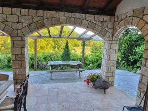 an outdoor patio with a picnic table and an archway at Chalet St John in Slatino