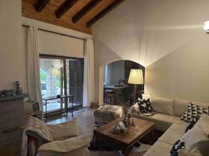 a living room with a couch and a table at Chalet St John in Slatino