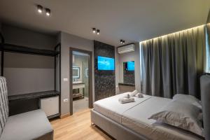 a bedroom with a bed and a large window at Ersa Luxury Rooms in Sarandë