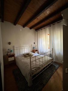 a bedroom with a bed in a room with windows at Chalet St John in Slatino