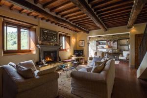 een woonkamer met 2 banken en een open haard bij Villa Valerie in Cortona