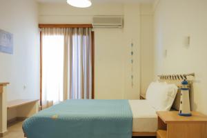 Postel nebo postele na pokoji v ubytování Faros Hotel
