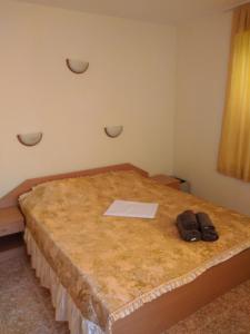 a bed with two pairs of shoes sitting on it at Rutland Bay in Ravda +15 photos