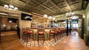a bar in a restaurant with a bunch of stools at The Newgrange Hotel in Navan