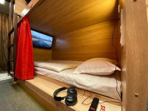 a small bedroom with a bed in a wooden cabin at STARS University Dormitory in Tashkent