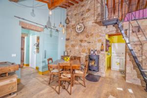 a dining room with a table and a wood stove at B&B Al Vecchio Forno in Montepulciano