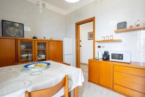 a kitchen with a table with a plate on it at Dimora Waterfront in Bari +19 photos