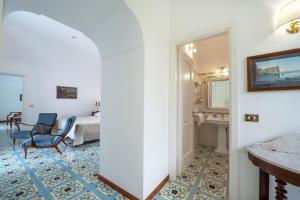 a corridor of a hotel room with a bedroom at Hotel Belvedere in Conca dei Marini