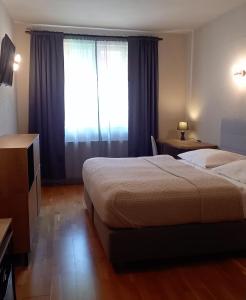 Una cama o camas en una habitación de Boutique Hotel Templ