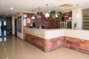 a bar in a restaurant with a brick wall at Checkin Diamar in Arrecife +36 photos