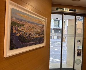 a painting of a city on a wall at Hostal Rambla in Sant Boi del Llobregat