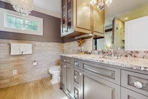 a bathroom with a sink and a toilet and a mirror at Lake Therapy in Lake Lure +13 photos