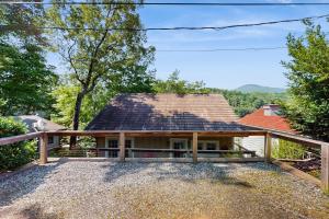 a house with a porch with a roof at Lake Therapy in Lake Lure