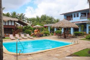 a swimming pool in front of a villa at Pousada Vivenda Oriente in São José da Coroa Grande