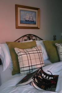 
a bed with pillows and a pillow on it at Horse & Groom B&B in Westbury
