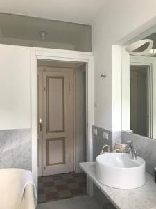 a bathroom with a sink and a large mirror at RL - Boutique Suites & Apartments in Bienno