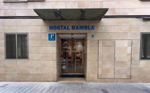 a building with a hospital railla in the front at Hostal Rambla in Sant Boi del Llobregat
