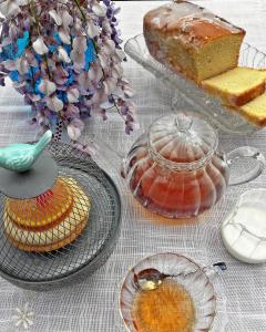 a table topped with cakes and plates and a cake at Hotel El Panorama in Tapia de Casariego