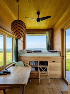 a bedroom with a bed and a table at Glamping Na Malém Háji in Hora Svaté Kateřiny