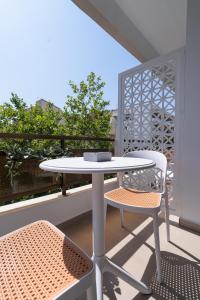 a white table and chairs on a balcony at Stylish Suite in Rhodes Town
