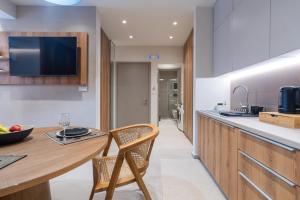 a kitchen with a wooden counter and a table and chairs at Stylish Suite in Rhodes Town +13 photos