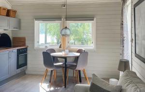 a kitchen with a table and chairs in a room at 2 Bedroom Stunning Home In Lavik in Lavik
