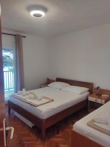 una camera da letto con un letto grande e una finestra di Apartmani Lučić, Marušići a Omiš (Almissa)