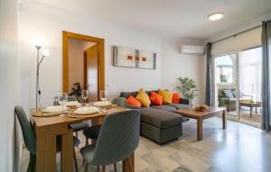a living room with a couch and a dining room table at Awesome Apartment In Benalmadena in Benalmádena
