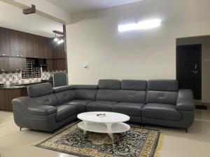 a living room with a couch and a coffee table at Naidu Nivasam in Secunderabad