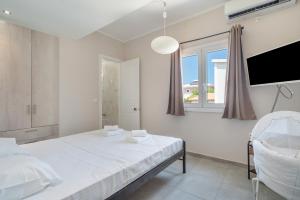 Postel nebo postele na pokoji v ubytování Stathis Home